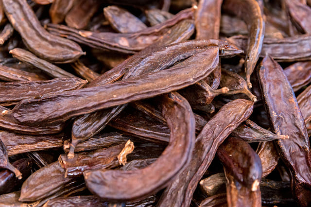 close-up-carob-pods-heap-ceratonia-siliqua-background.jpg